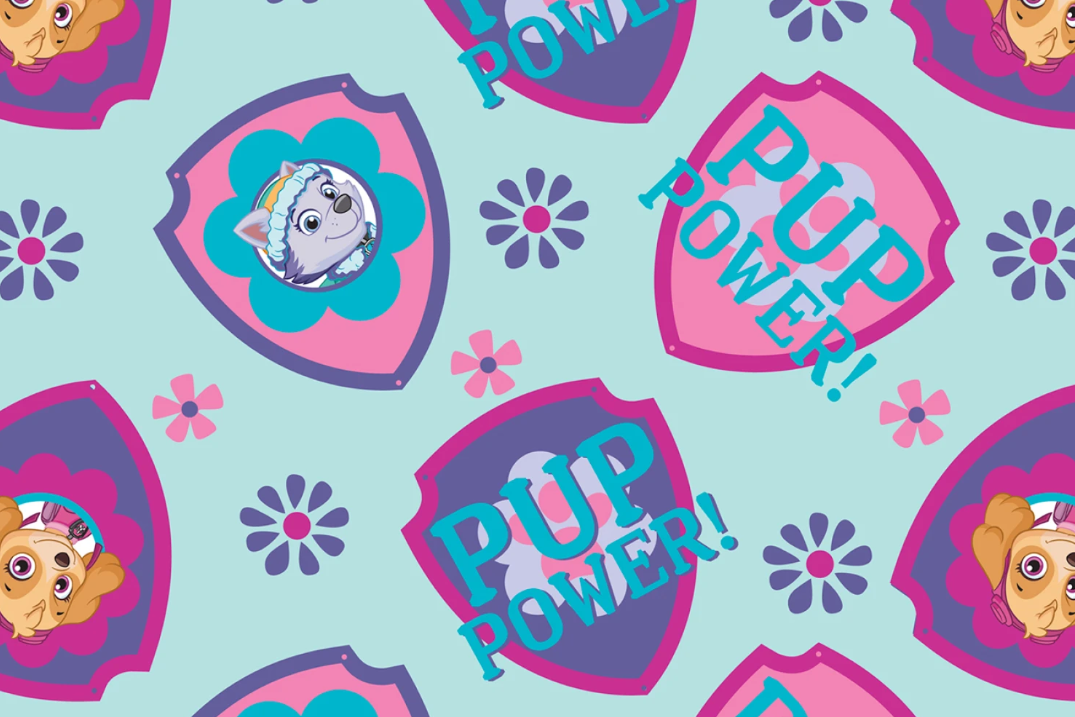 A repeating cartoon pattern on a light aqua background, featuring pink and purple shield-shaped badges with the words “PUP POWER!” and small flower motifs. The central badge shows a white puppy illustration, and the surrounding badges include cropped puppy faces in tan and cream tones.