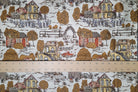 A close-up of a fabric pattern featuring a classic toile design of rural houses, trees, and a red truck on a white background, with a wooden ruler showing measurements across the bottom to indicate scale.