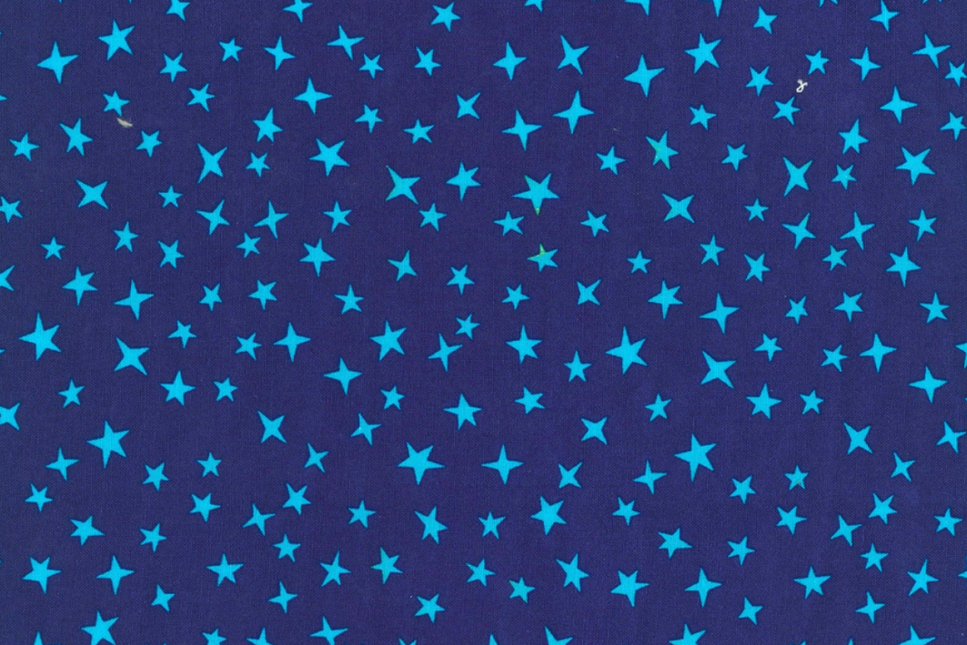 A close-up of a fabric pattern featuring small, bright blue stars scattered across a dark navy blue background.