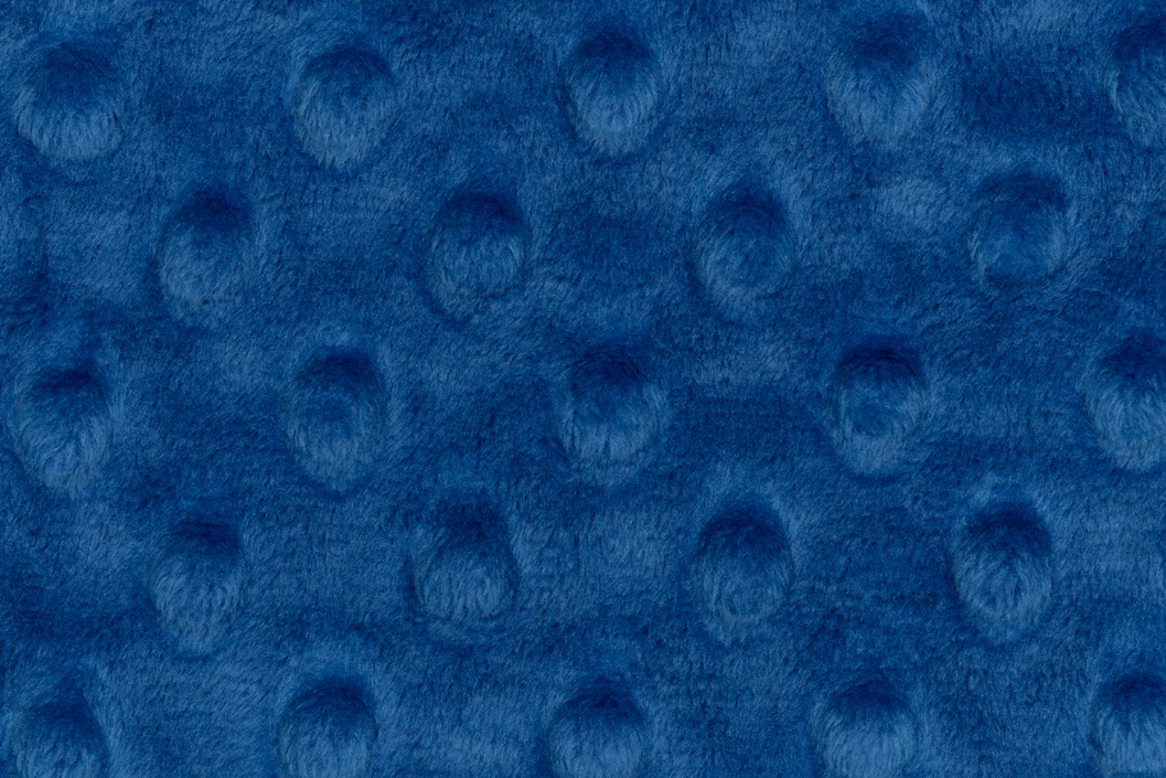 Close-up of blue textured fabric with circular patterns
