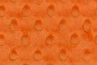 Orange fabric with a textured pattern