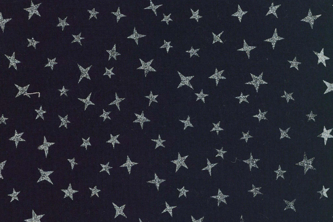 Dark navy blue fabric with a repeating pattern of small silver glitter stars.